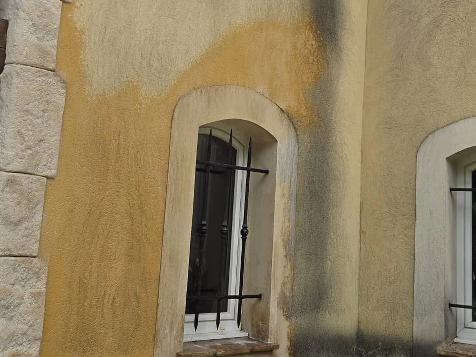 Façade en enduit ocre avant après nettoyage des coulures noires par Toiture Winter Père & Fils — avant